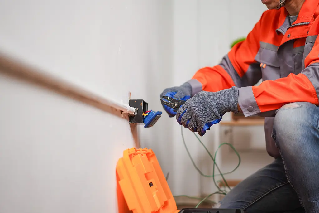 An electrician upgrading an electrical outlet. Contact Mr. Bright Electric for your electrical upgrade needs in Clark or Cowlitz Counties.