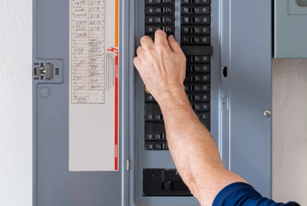 A Mr Bright Electric technician testing a breaker panel