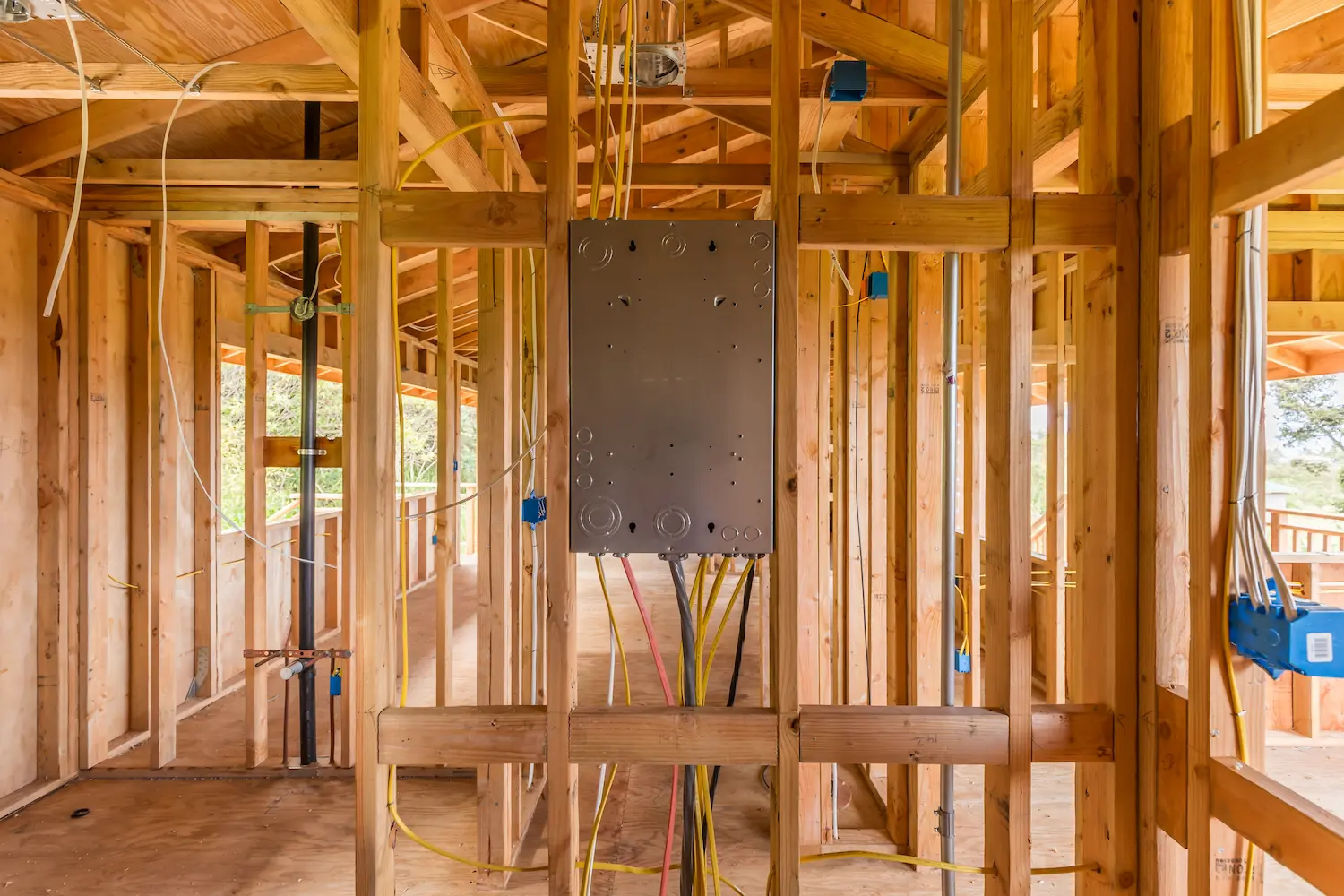 a newly installed electrical panel in a home under construction